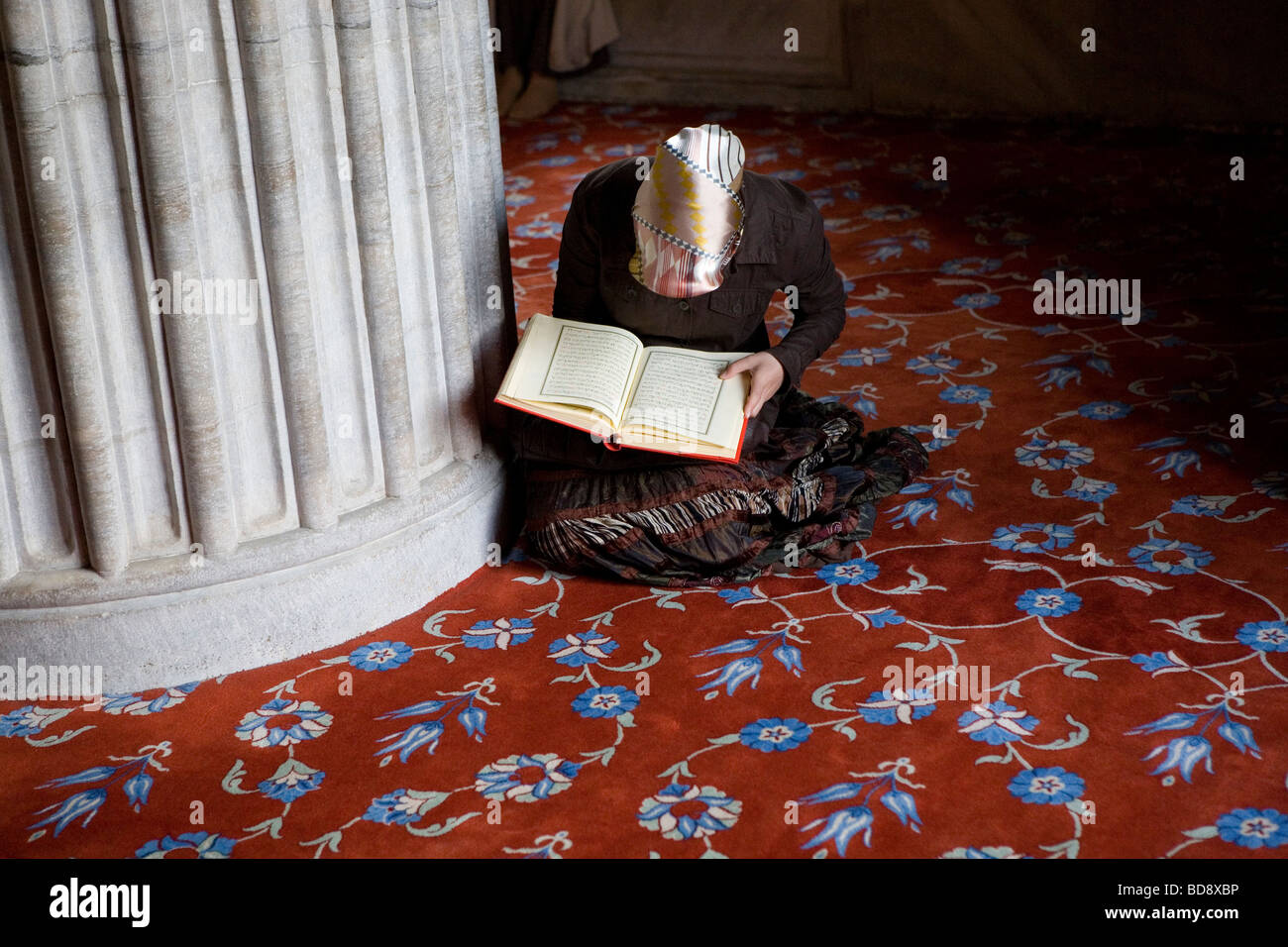 girl reads in Koran, Mosque Turkey Stock Photo