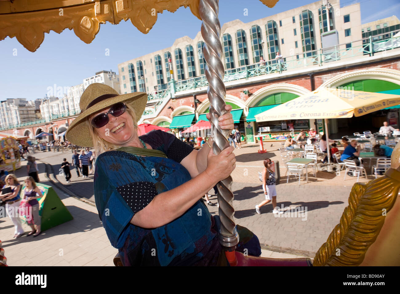 Brighton Merry go round Britain England Holiday Staycation happy enjoy Summer Sunshine Hot beach Blue sky August woman laugh me Stock Photo