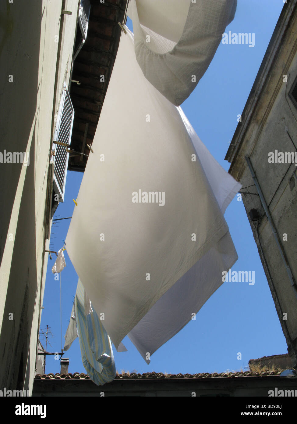 bed sheets on washing line outdoors in sun in italy Stock Photo Alamy