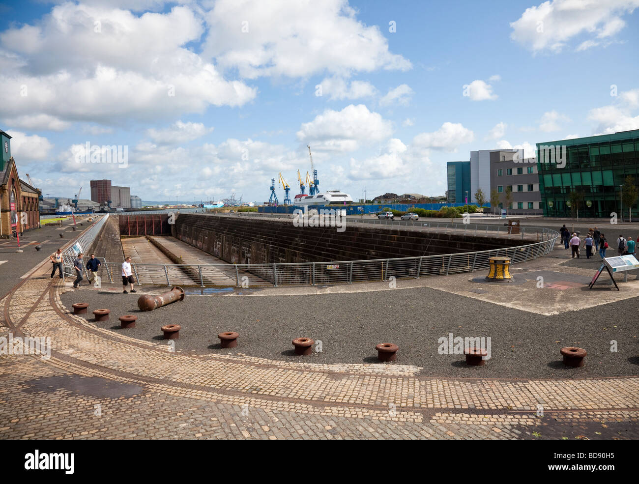 Thompson Dock, the graving dock of the RMS Titanic, Belfast, Northern Ireland, with tourists, some on an organised tour. Stock Photo