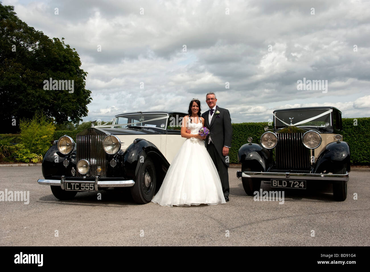 Bride with her father and two old Rolls Royce cars Stock Photo
