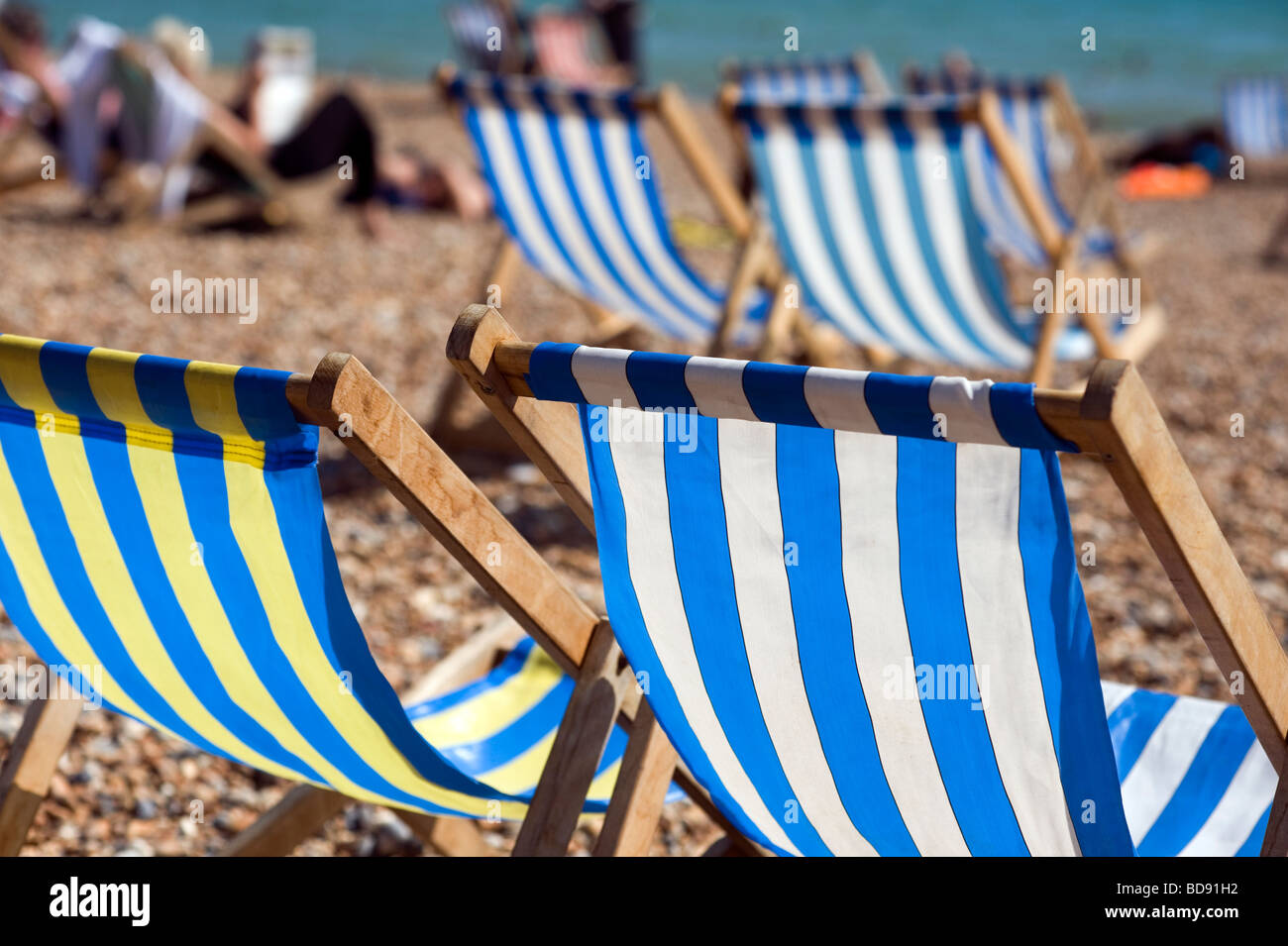 Brighton Britain England Holiday Staycation happy enjoy Summer Sunshine Hot beach Blue sky August deck chairs blue blue stripes Stock Photo