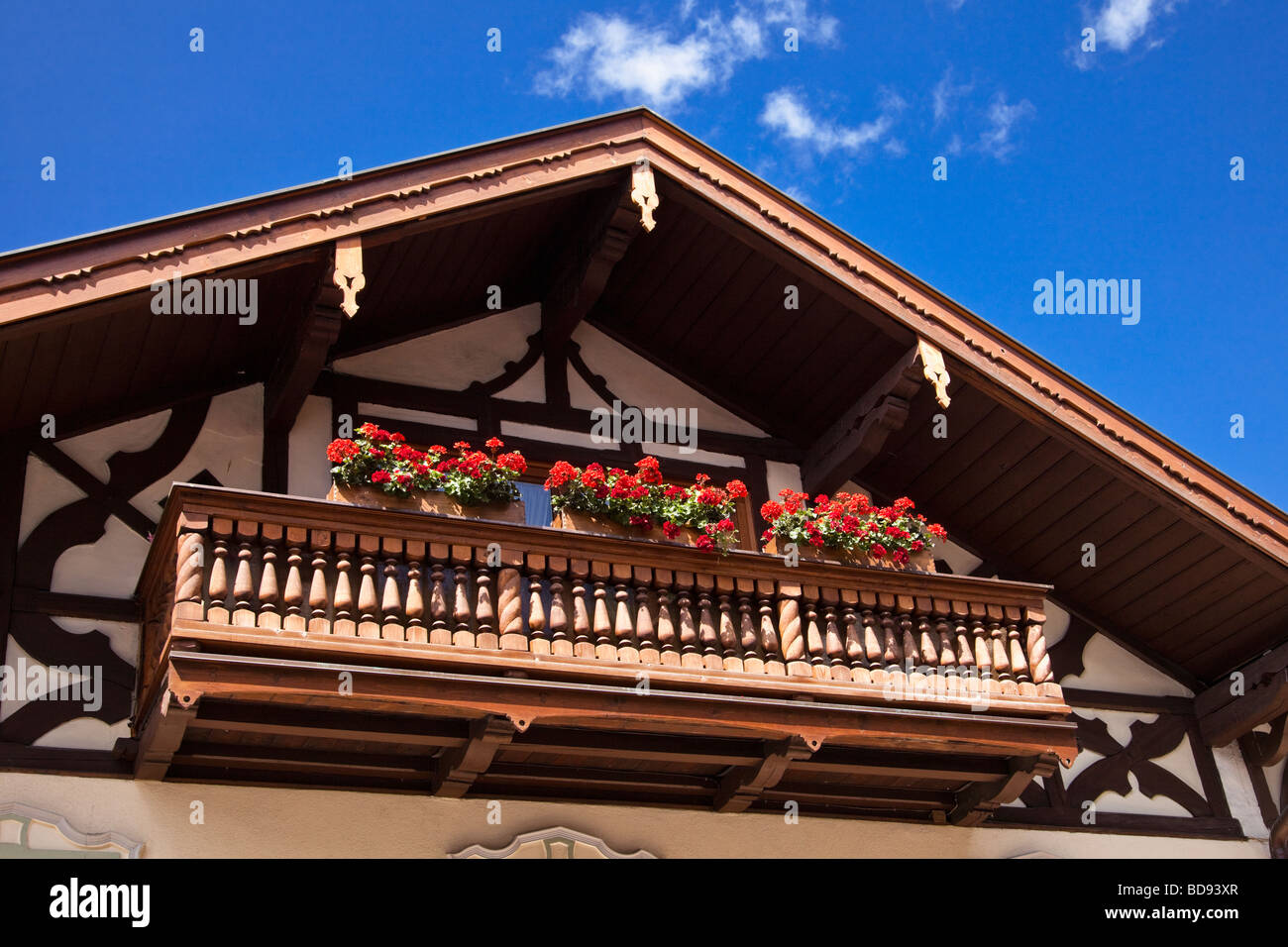 Traditional German balcony with flowers in window boxes on half