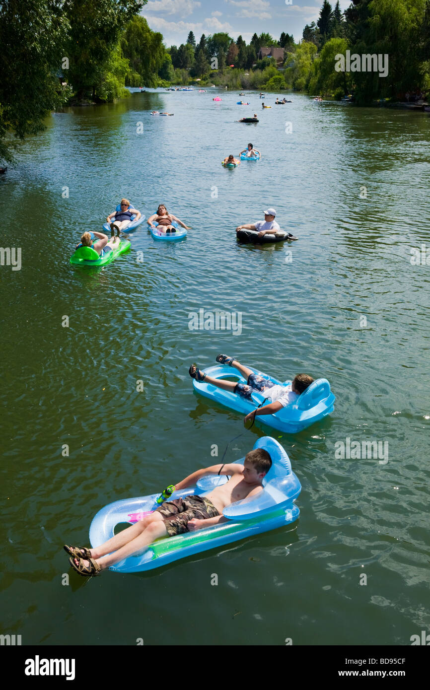 Many people leisurely floating on rafts down the Deschutes River on