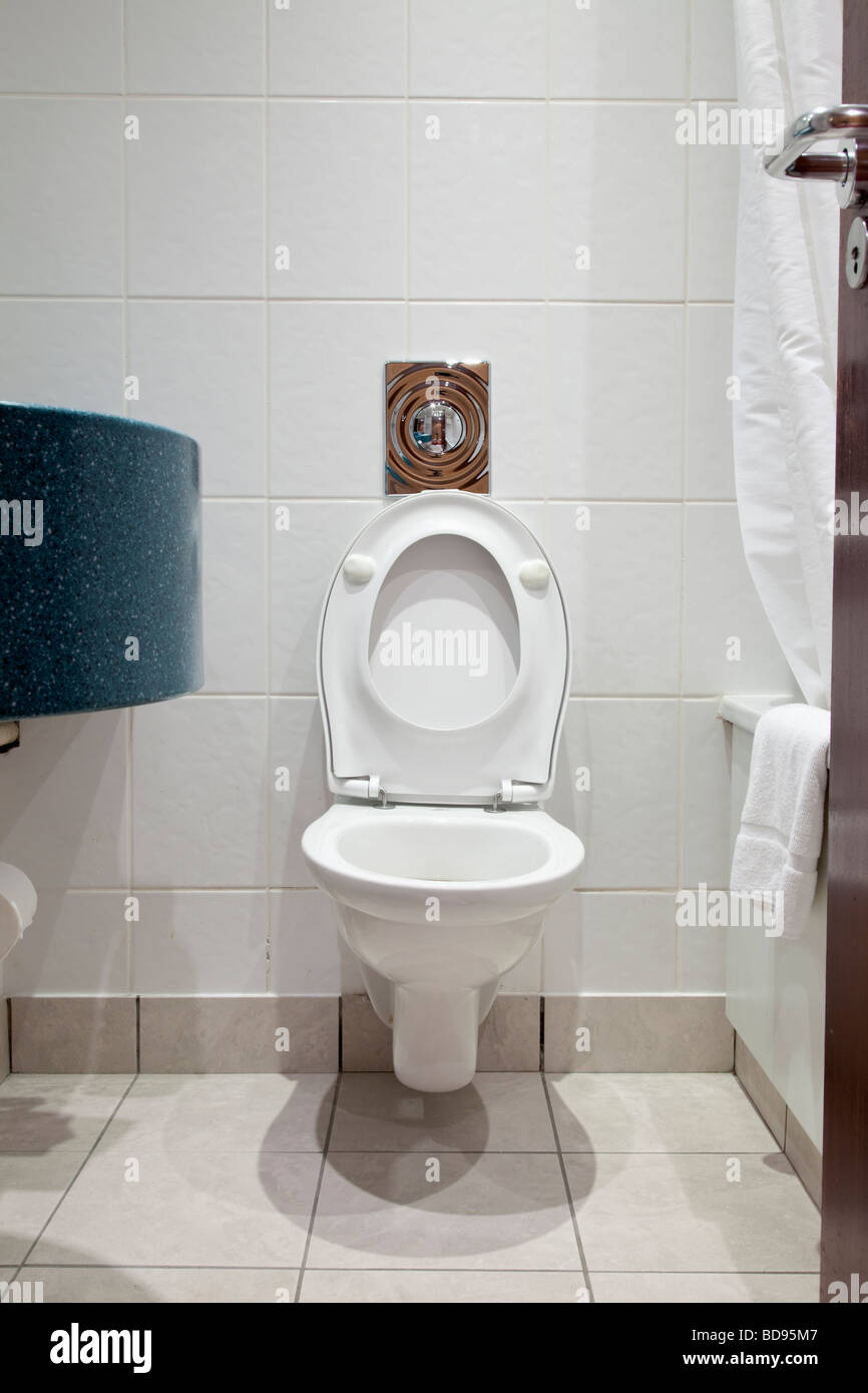 Toilet WC in a hotel bathroom lid and seat up Stock Photo