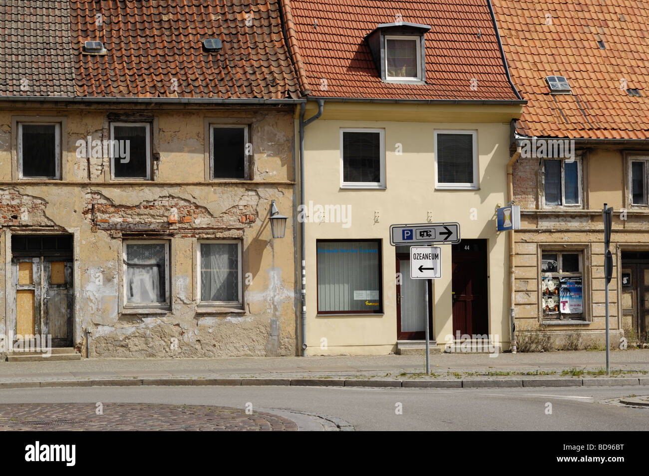 Houses in state of deterioration next to a reconstructed one in old town Stralsund - Germany Stock Photo