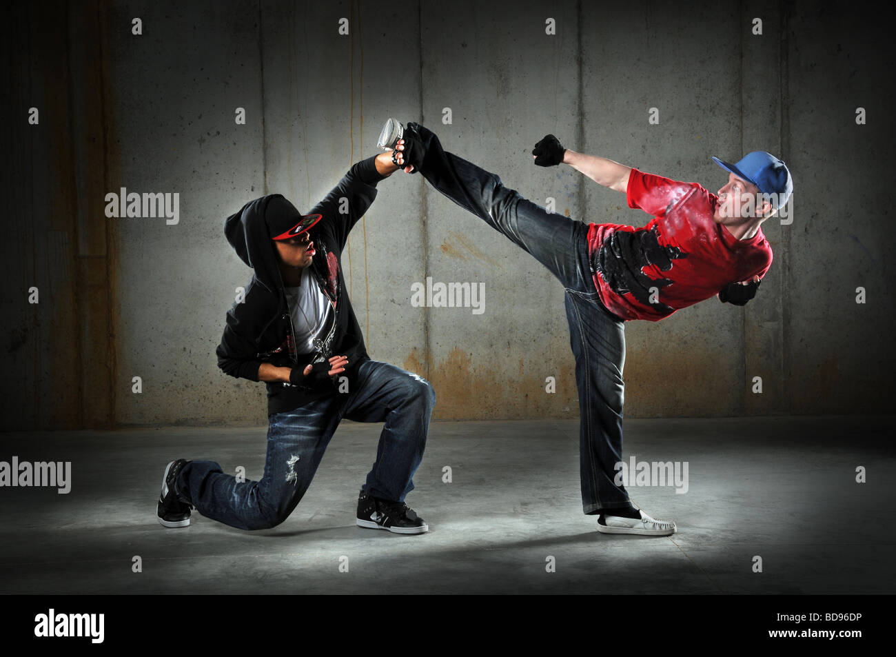 Hip hop men dancing performing a martial arts move Stock Photo