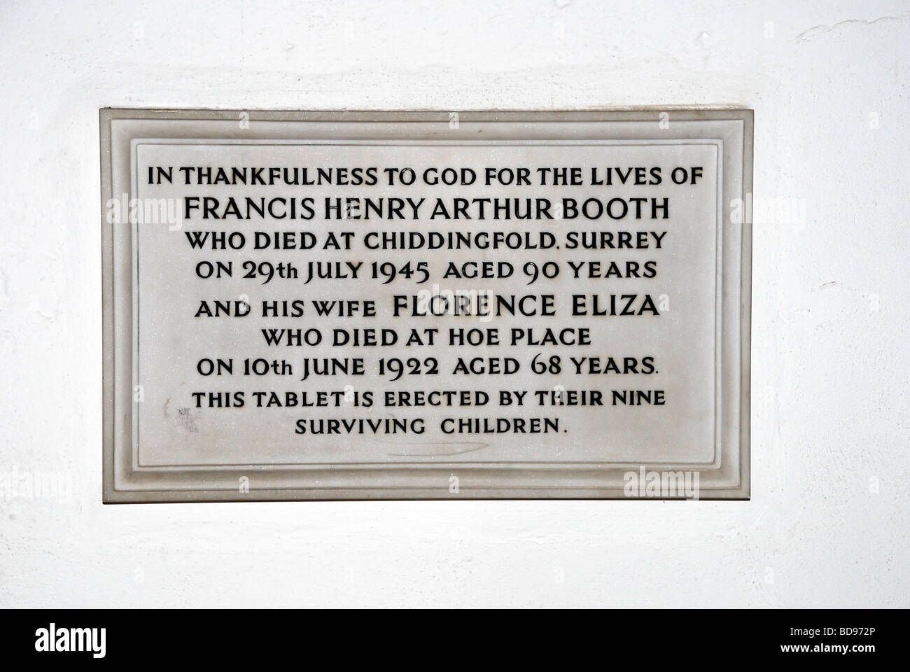 Plaque in memory of Francis Henry Arthur Booth and his wife Florence Eliza Booth in St Peter s Church in Old Woking Surrey Stock Photo