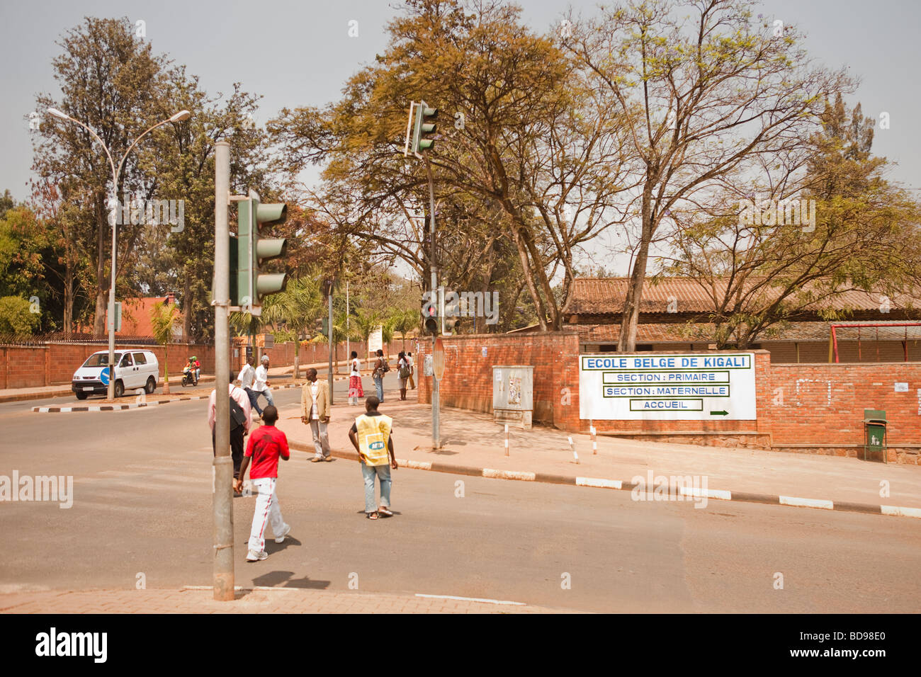 People walk by the Belgian School Ecole Belge de Kigali in downtown Kigali Rwanda Stock Photo
