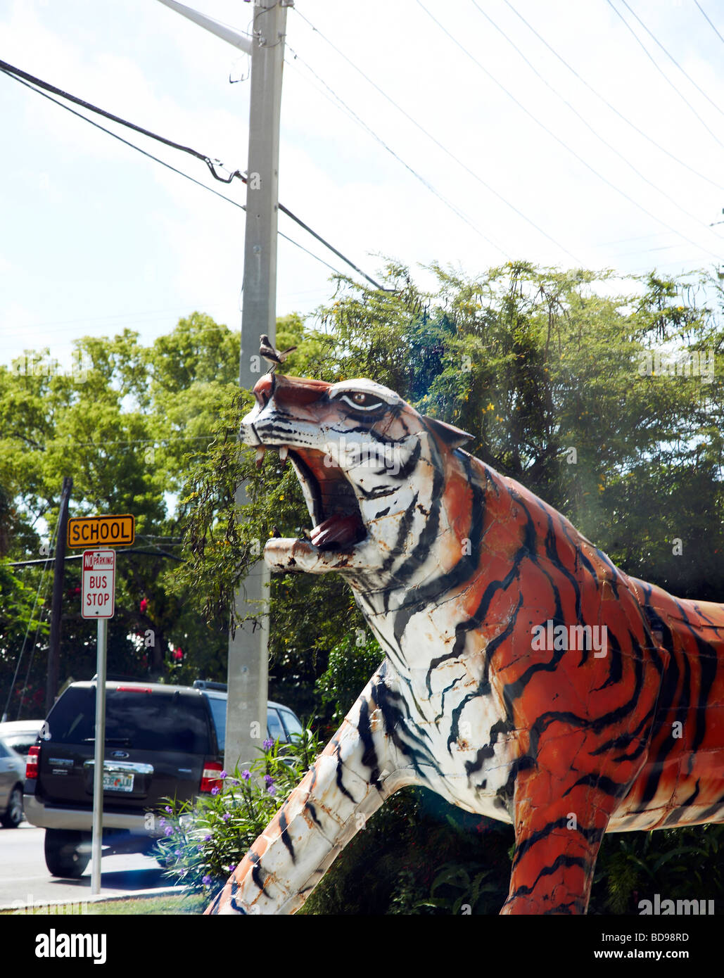 Sculpture of a roaring tiger with a bird sat on its nose Stock Photo