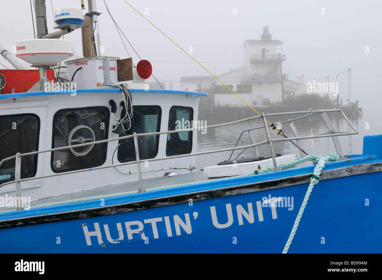 Blue fishing boat in fog at Fisherman's Cove Eastern Passage Halifax