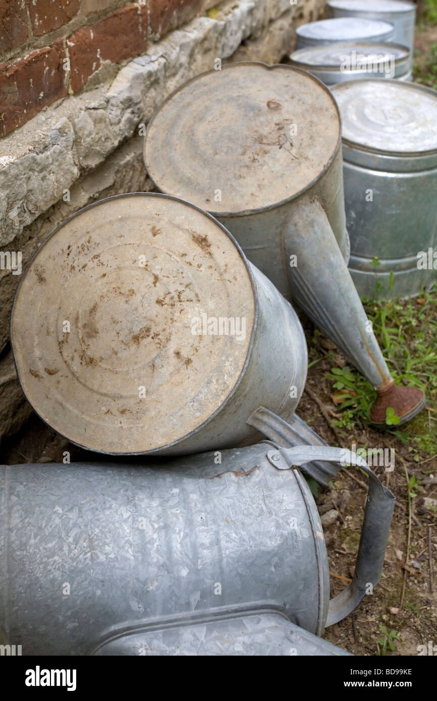 Buckets and watering pails along a wall Stock Photo