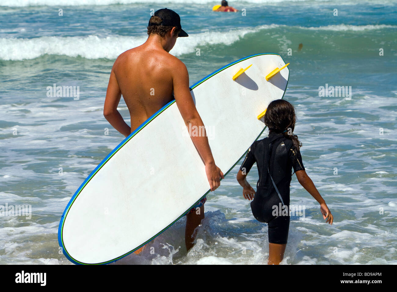 Young girl getting surfing lessons at Surf camp at Del Mar Beach in San