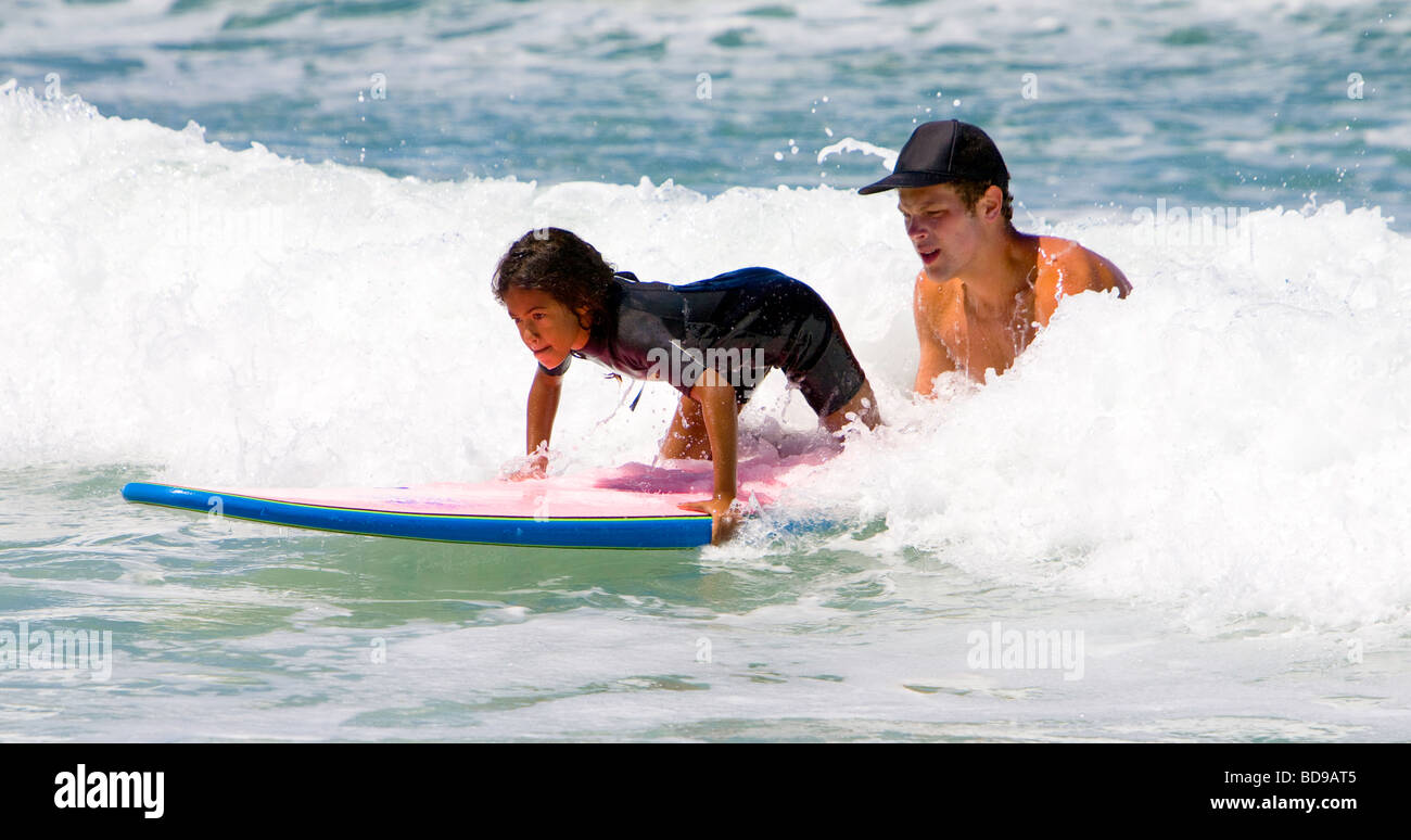 Young girl getting surfing lessons at Surf camp at Del Mar Beach in San