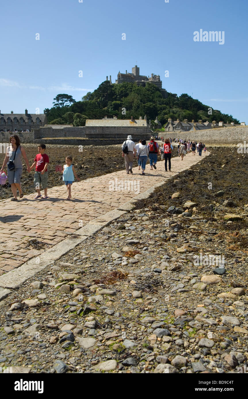 Tourists crossing the causeway at low tide to St Michael's Mount from Marazion on the Cornish mainland. Stock Photo
