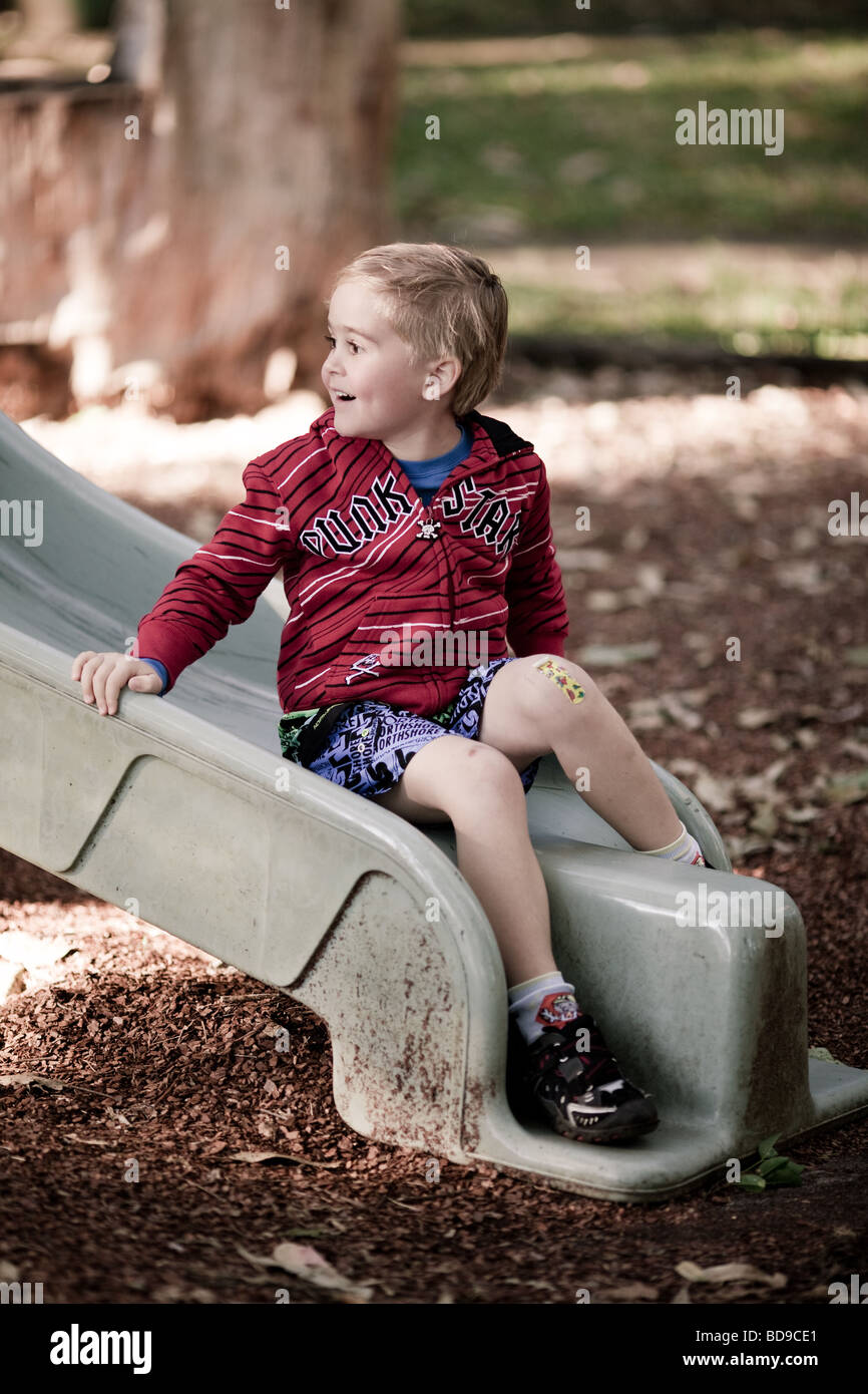 happy young boy in shady playground Stock Photo - Alamy