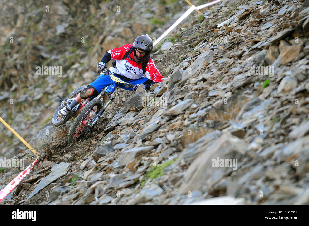 A mountain biker races downhill competing in the MTB Enduro of Nations