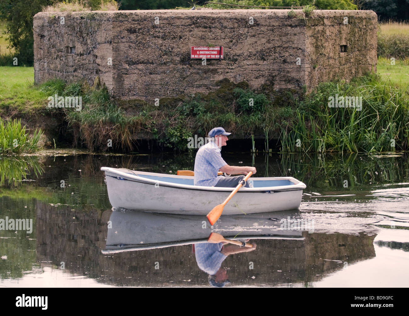 An old man rowing a boat Stock Photo