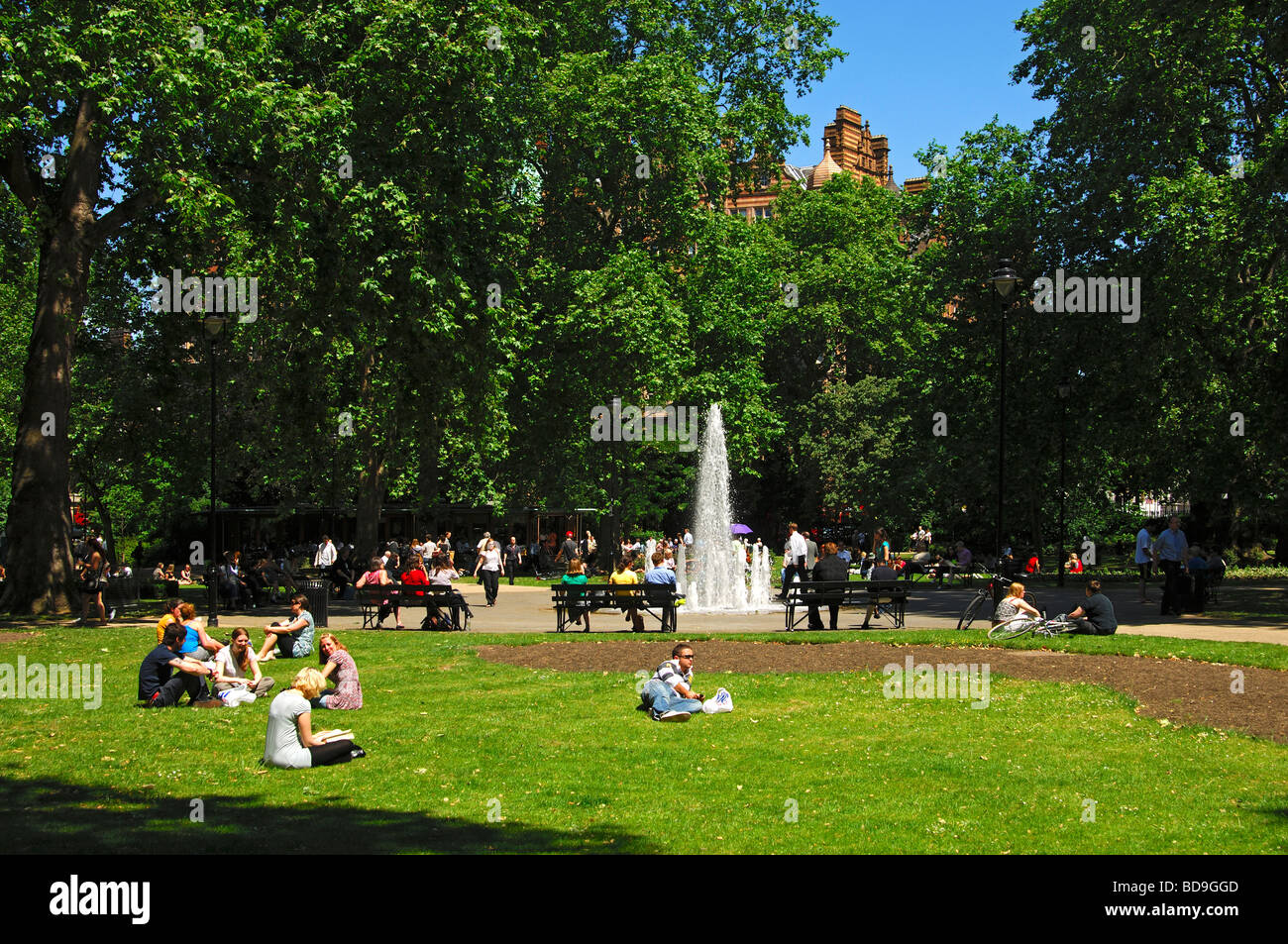 Park scene with fountain in Russell Square Gardens in Bloomsbury on a warm summer day, London, United Kingdom Stock Photo