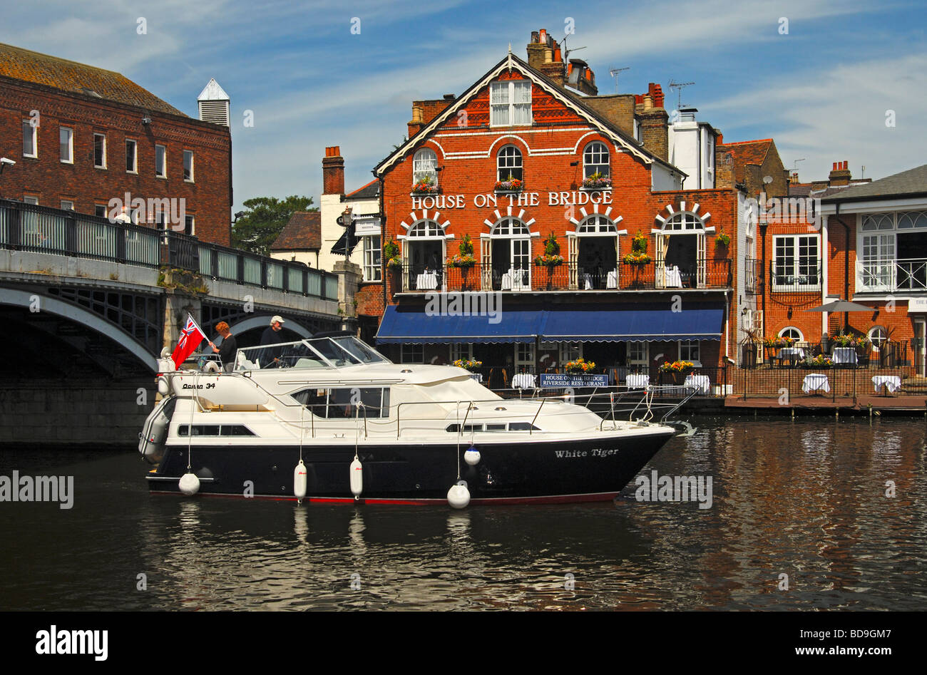 Motorboat passing the House on the Bridge Riverside Restaurant at the Windsor Bridge, Eton, United Kingdom Stock Photo