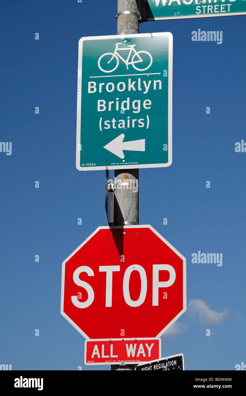 A road direction sign for stairs leading to Brooklyn Bridge and a Stop sign, Brooklyn, New York, United States. Stock Photo