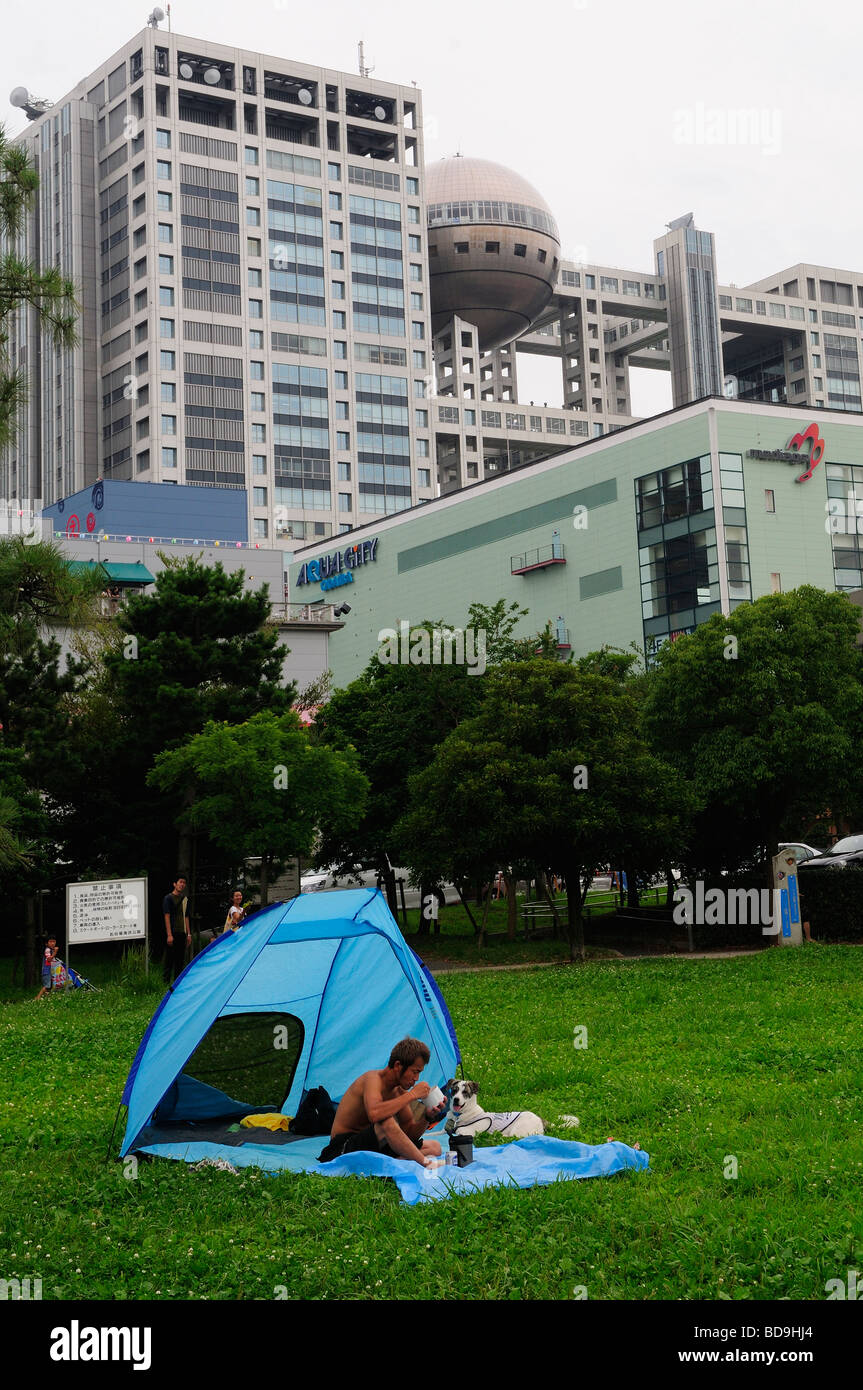 Man with his dog camping in the large artificial Odaiba island in Tokyo Bay, Japan Stock Photo
