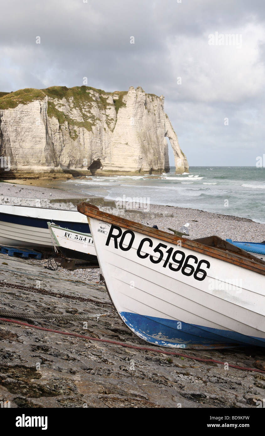 Fishing boats on the beach at Etretat in Normandy with the cliffs and ...