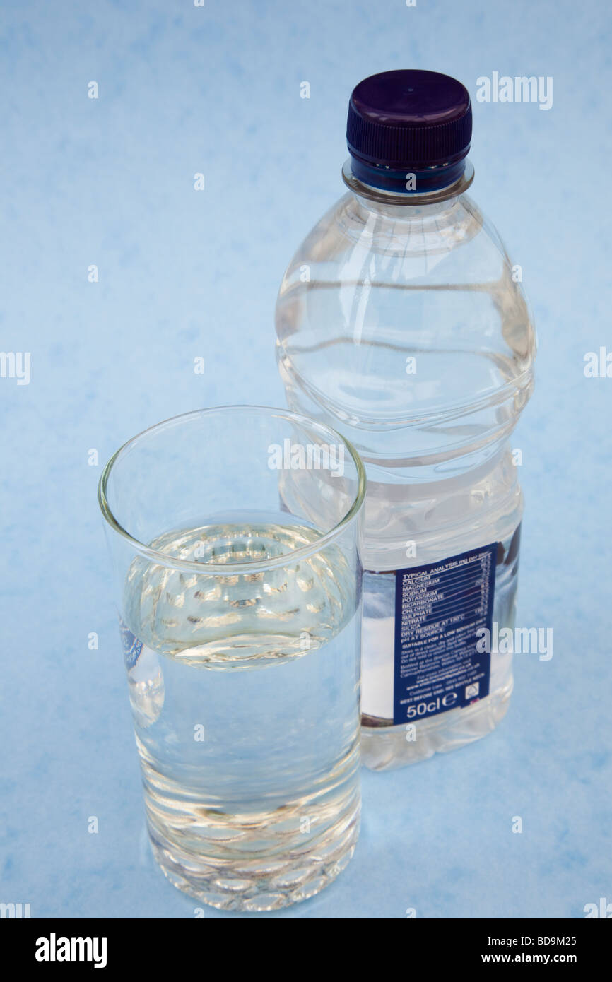 Studio still life Plastic bottle of pure still mineral water with glass Stock Photo