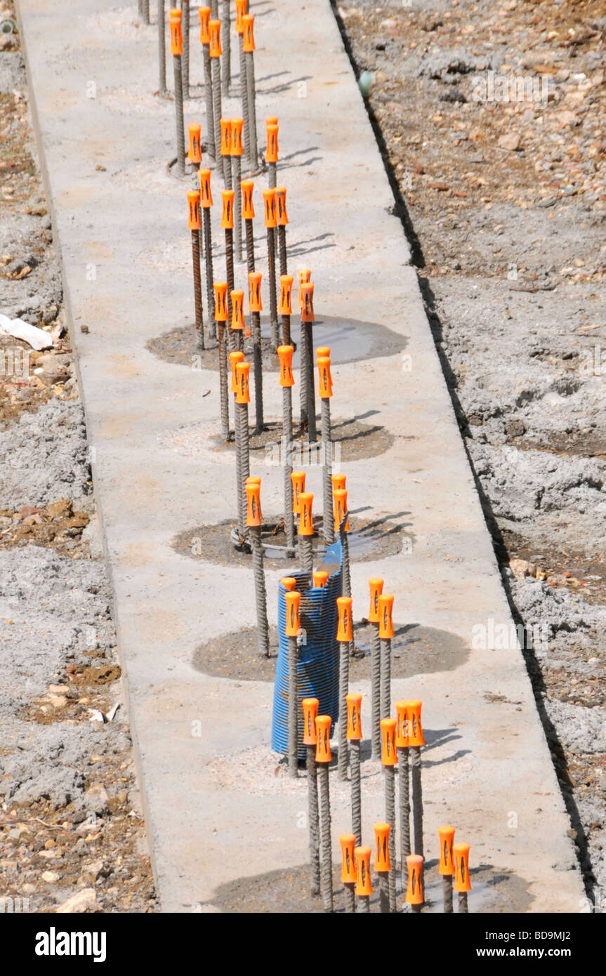 Bright orange safety caps fitted to ends of projecting steel
