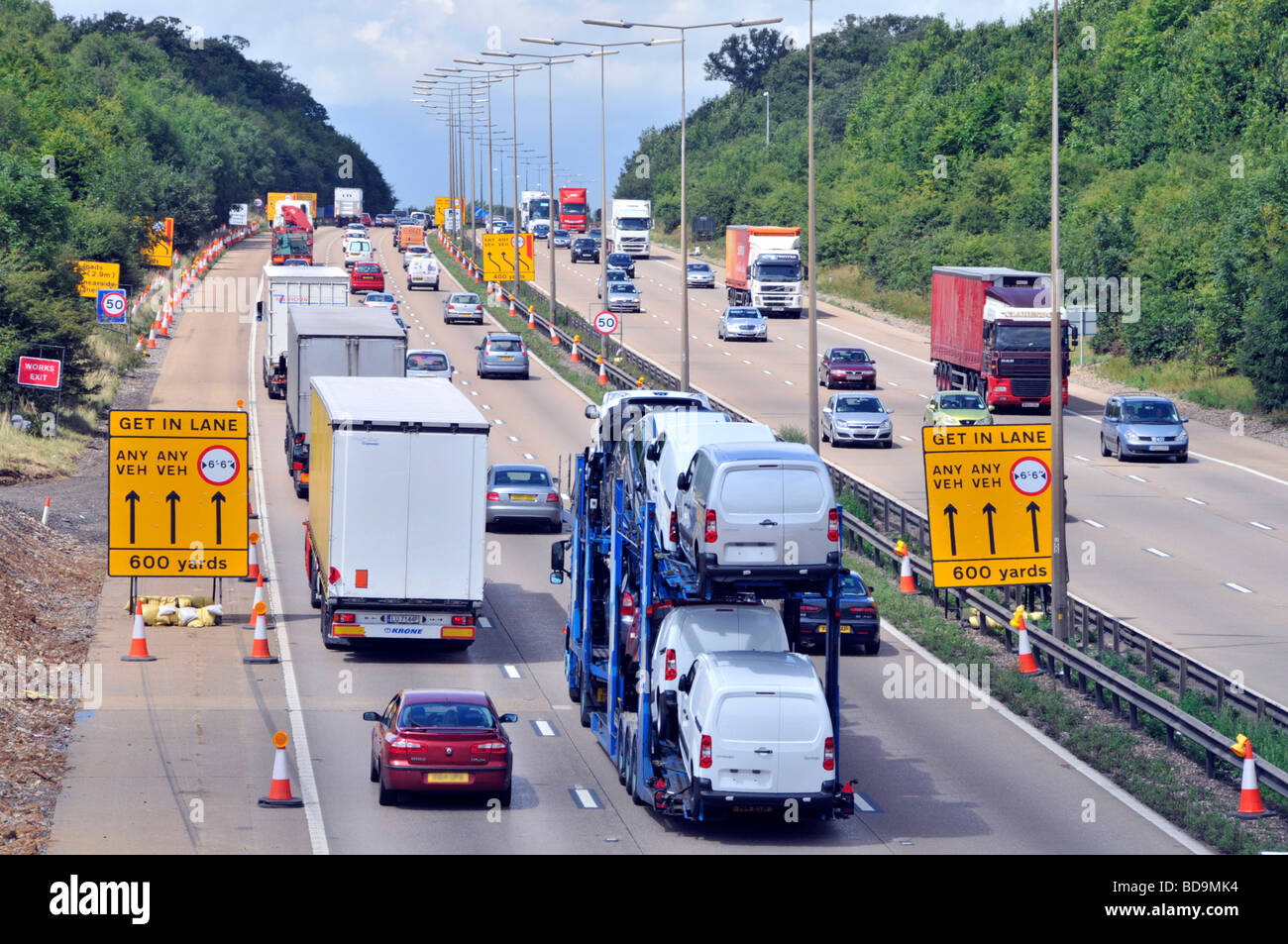 M25 motorway widening lane switching signs on approach to roadworks Stock Photo