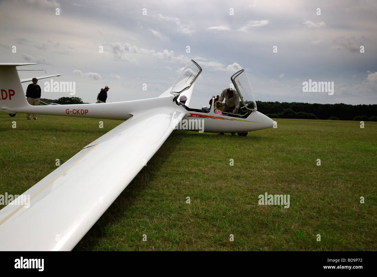 An Instructor prepares to take a female pilot for instruction in an ASK 21 Glider at the Kent gliding Club England UK Stock Photo