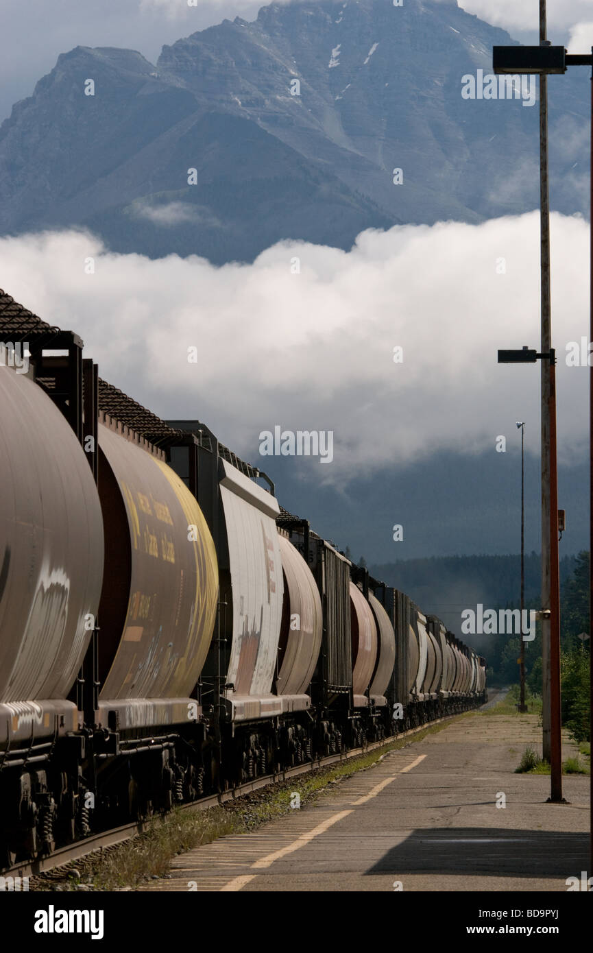 Freight train rattling through Banff Station in the early morning Stock Photo