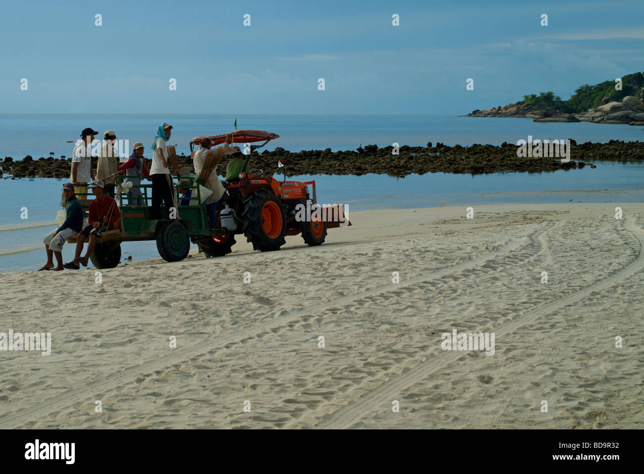 Full moon party clean up crew cleaning Haad Rin Beach in the morning. Stock Photo
