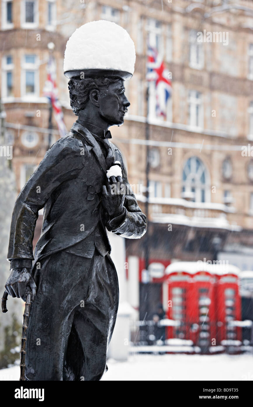 Snow on Charlie Chaplin statue Leicester Square London England Stock Photo