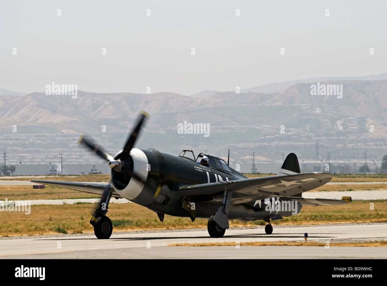 A Republic P-47G Thunderbolt taxis on the runway after flying at an air show. Stock Photo