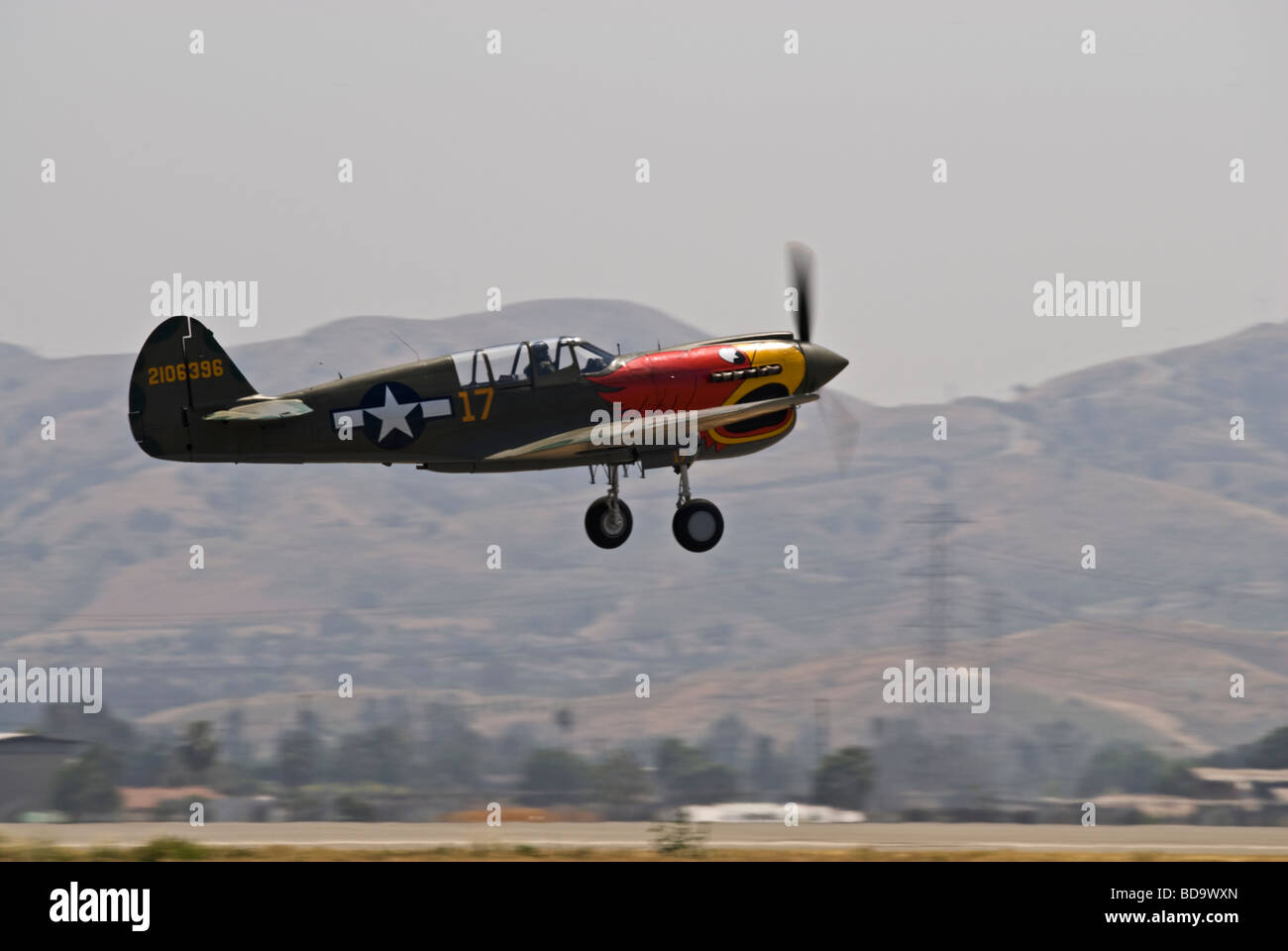 A Curtiss P-40N Warhawk lifts off the runway at an air show Stock Photo ...