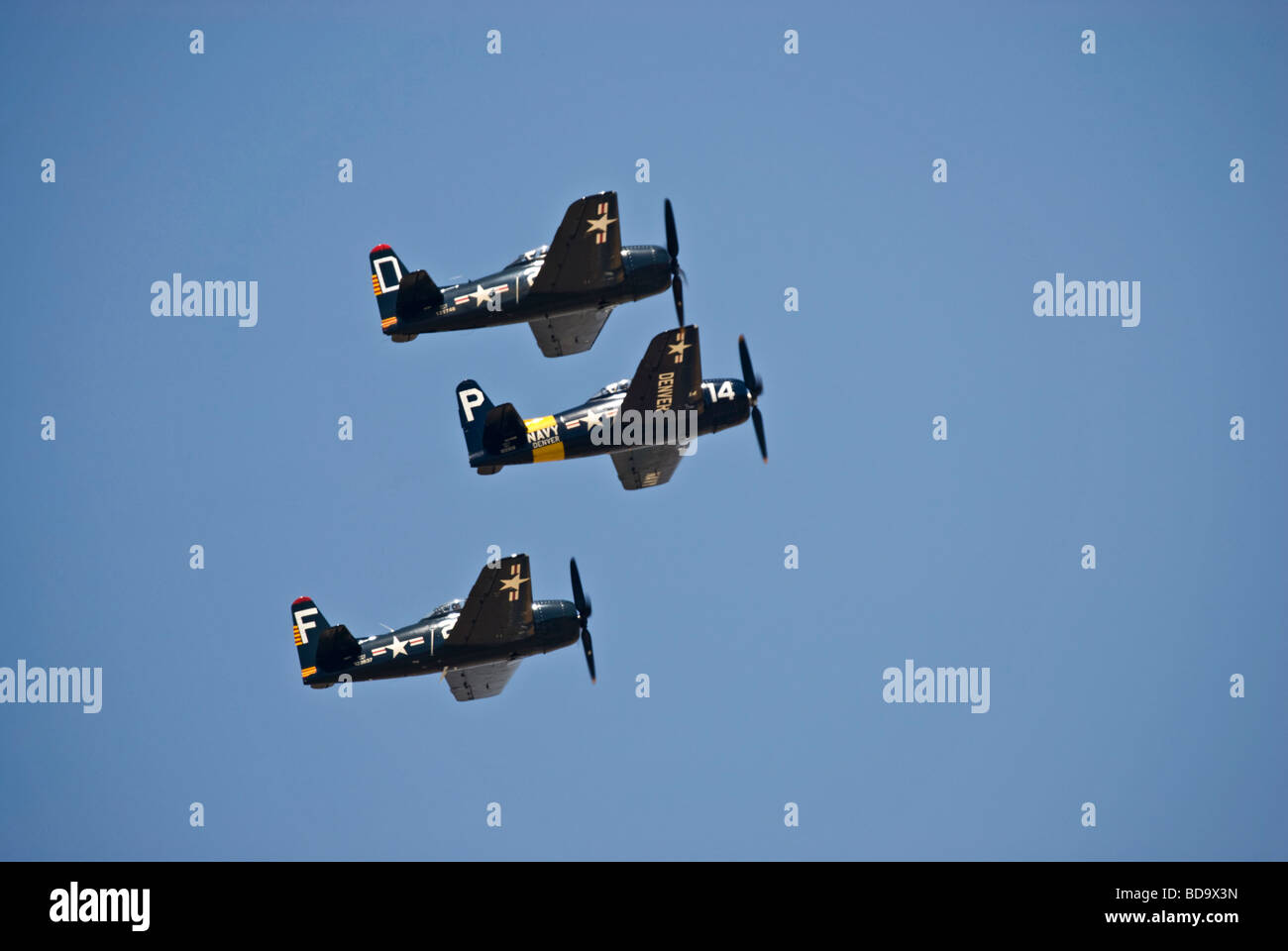 A 3-plane formation Grumman F8F Bearcats flies at an air show. Stock Photo