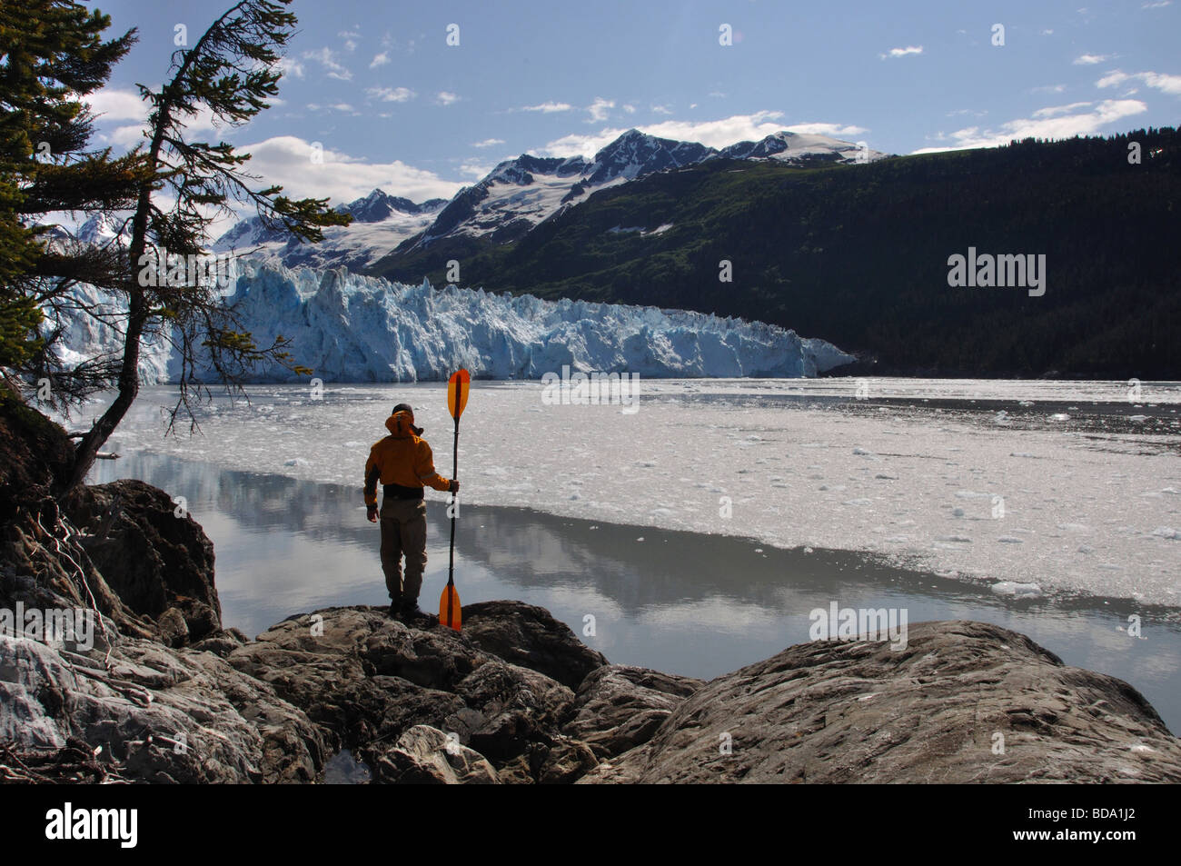 A sea kayaker views Mears glacier in Alaska's Prince William Sound Stock Photo