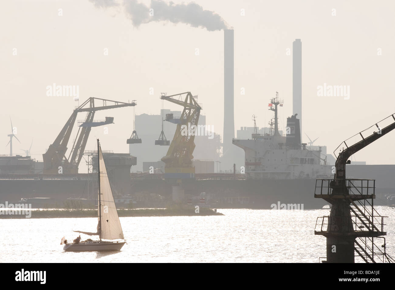 Amsterdam Harbor with loading docks, freighter, sailing ship and the Nuon Hemweg coal-fired and natural-gas fueled power plants. Stock Photo