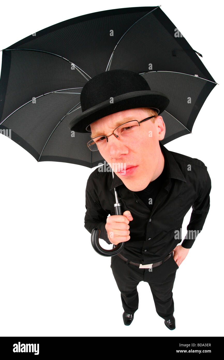young man with bowler hat and umbrella waiting for rain Stock Photo