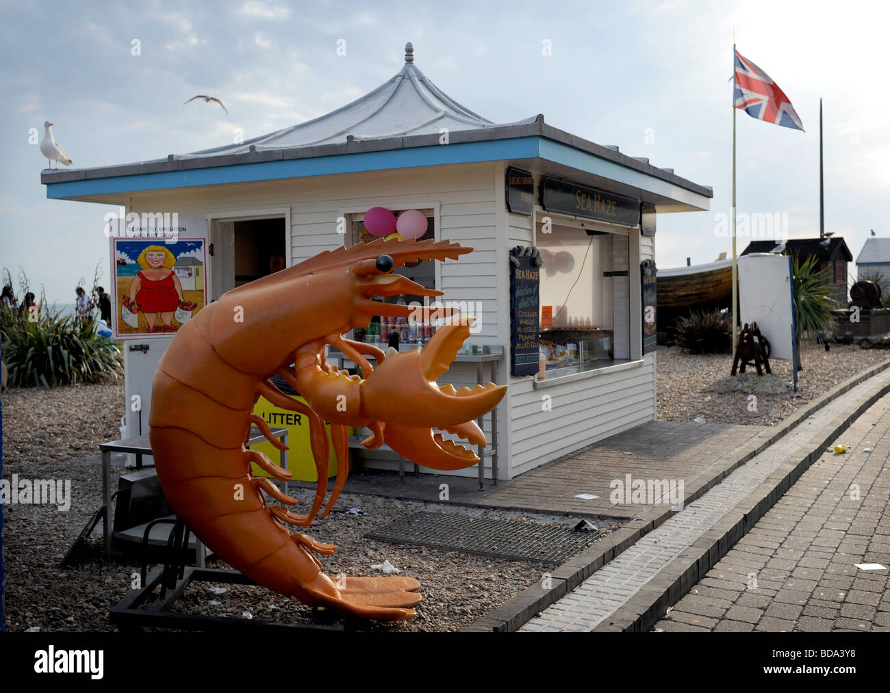 Giant plastic prawn outside shellfish kiosk on Brighton seafront beach