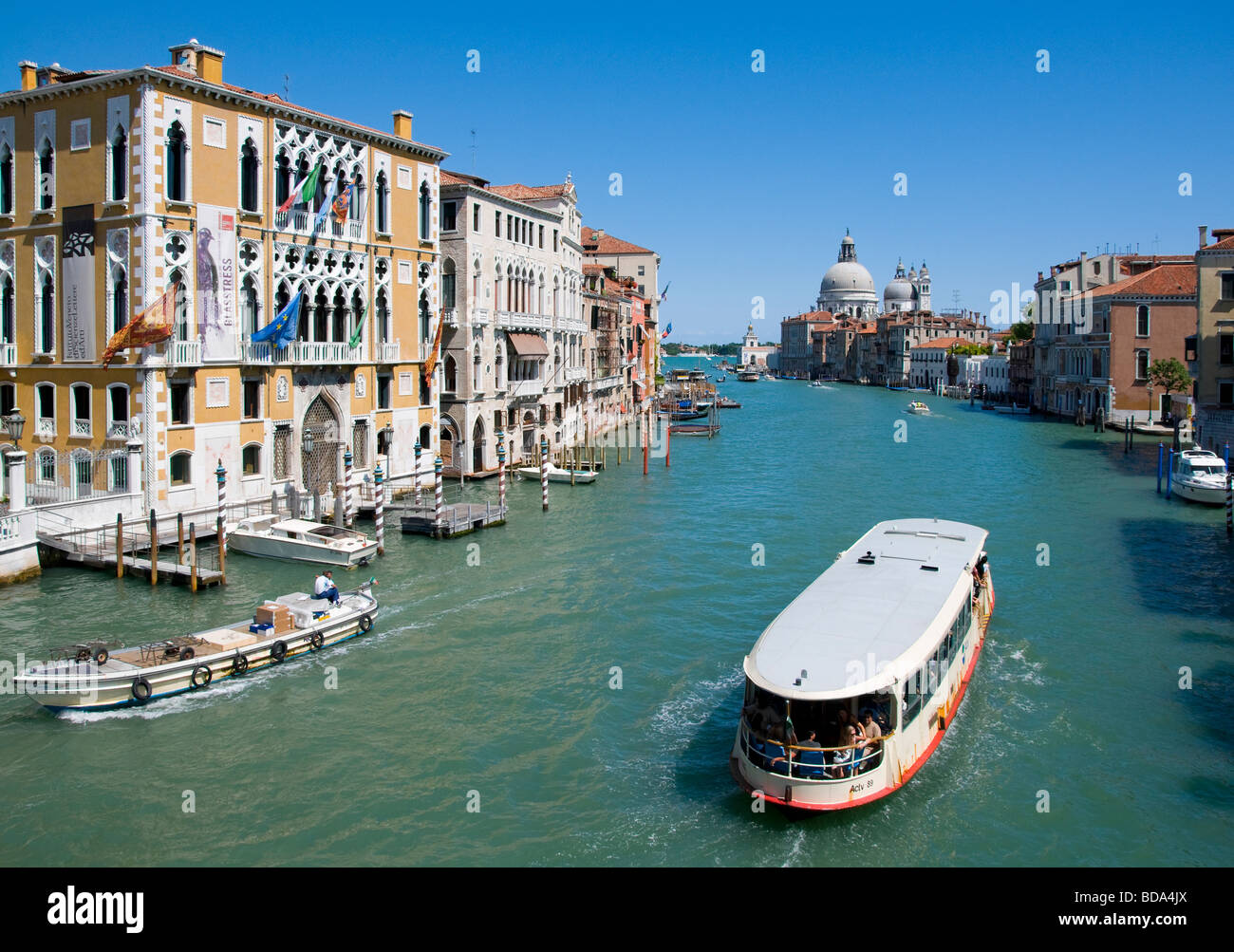 Venice, Veneto, Italy. Church of Santa Maria della Salute and Grand Canal from the Ponte dell'Accademia. Vaporetto / water bus Stock Photo