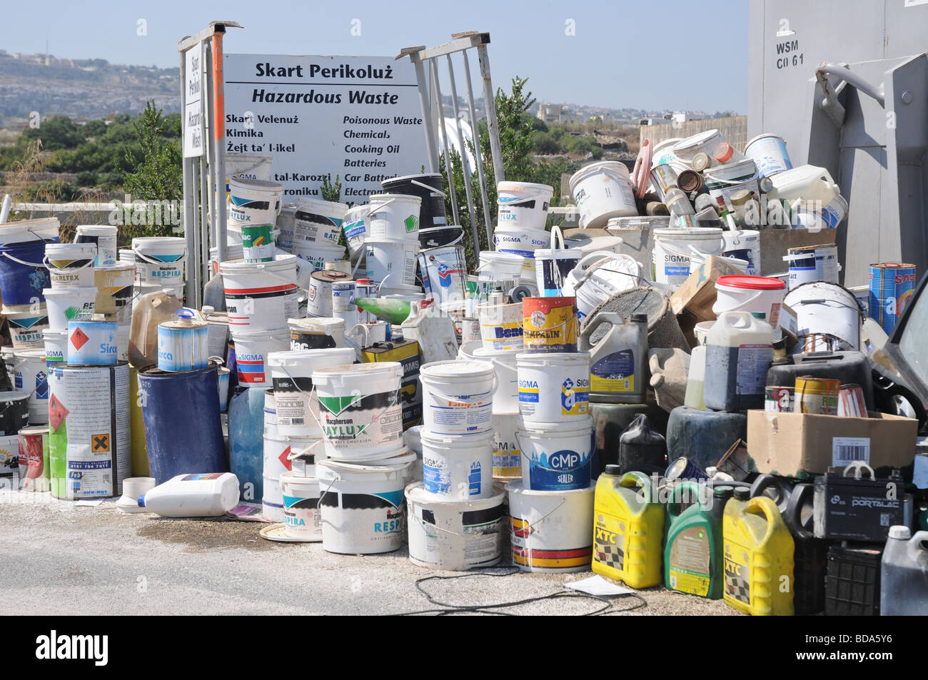 Paint buckets and fuel containers ready to be recycled at a waste management plant in Malta. Hazardous waste directive Stock Photo