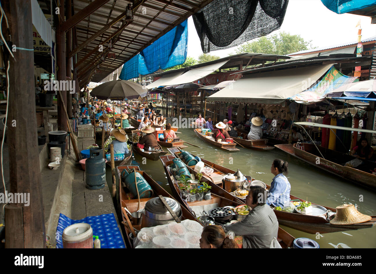 Food and kitchen boats fill the canal at the floating market at Damnoen Saduak near Bangkok Stock Photo
