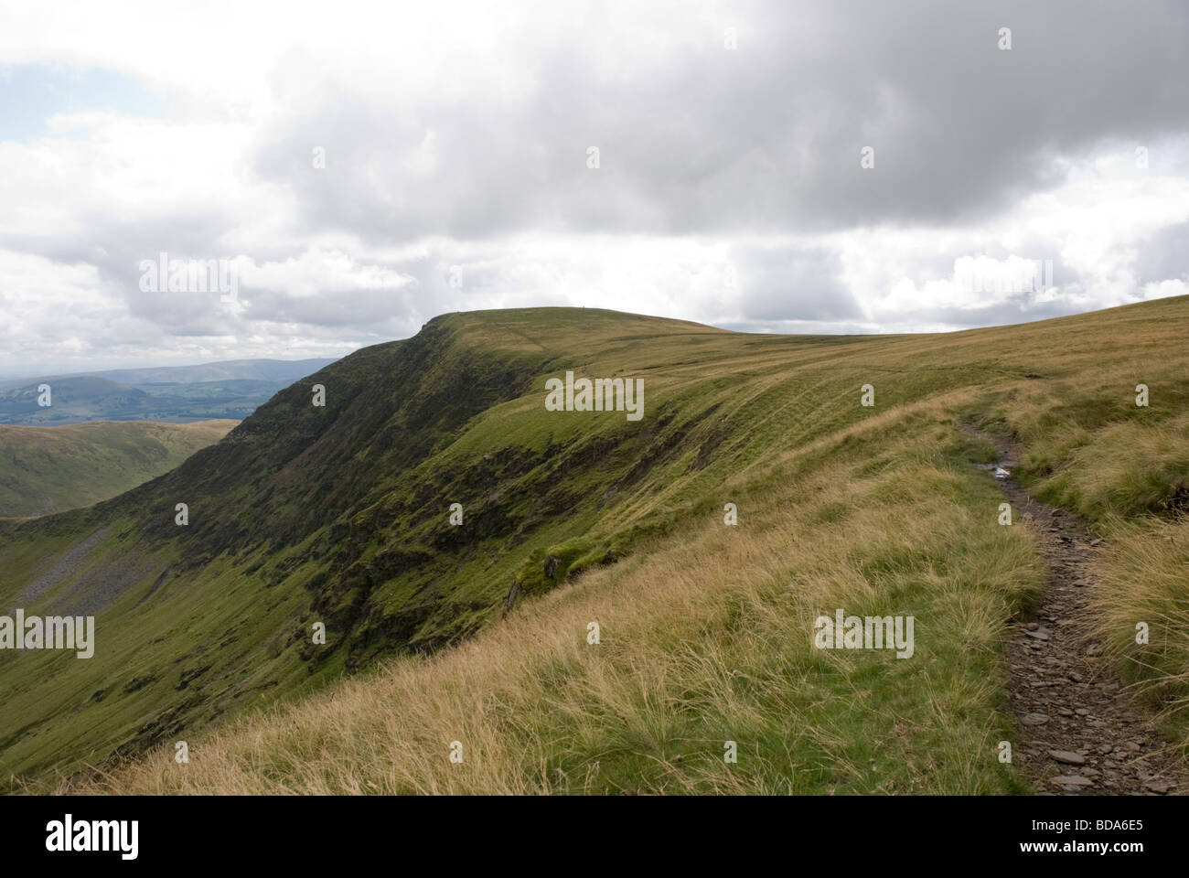 A view along a Lake District footpath, along a ridge that leads from Bowscale Fell, towards the summit of Bannerdale Crags,  Cumbria. Stock Photo