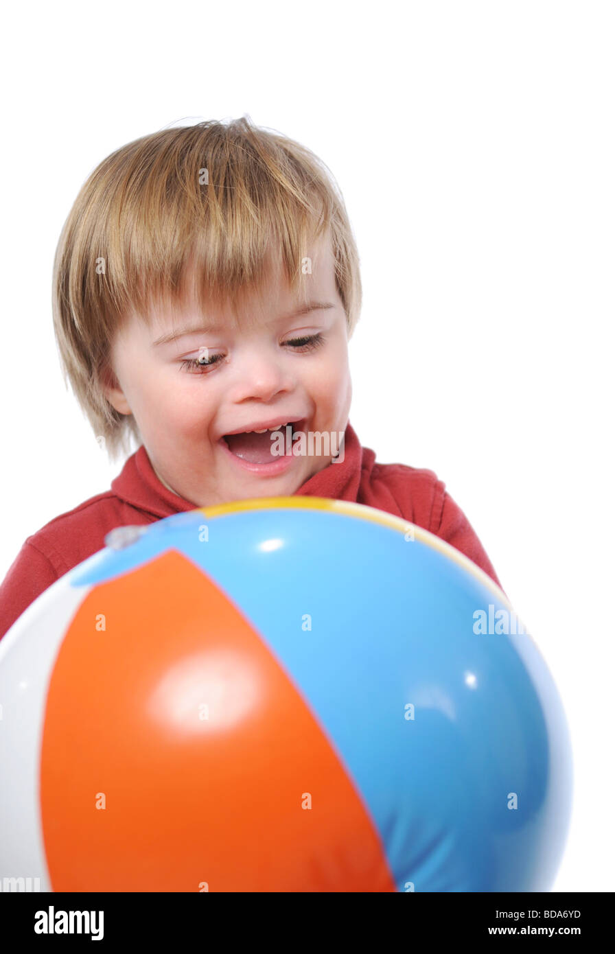 Child with down syndrome playing with a ball Stock Photo