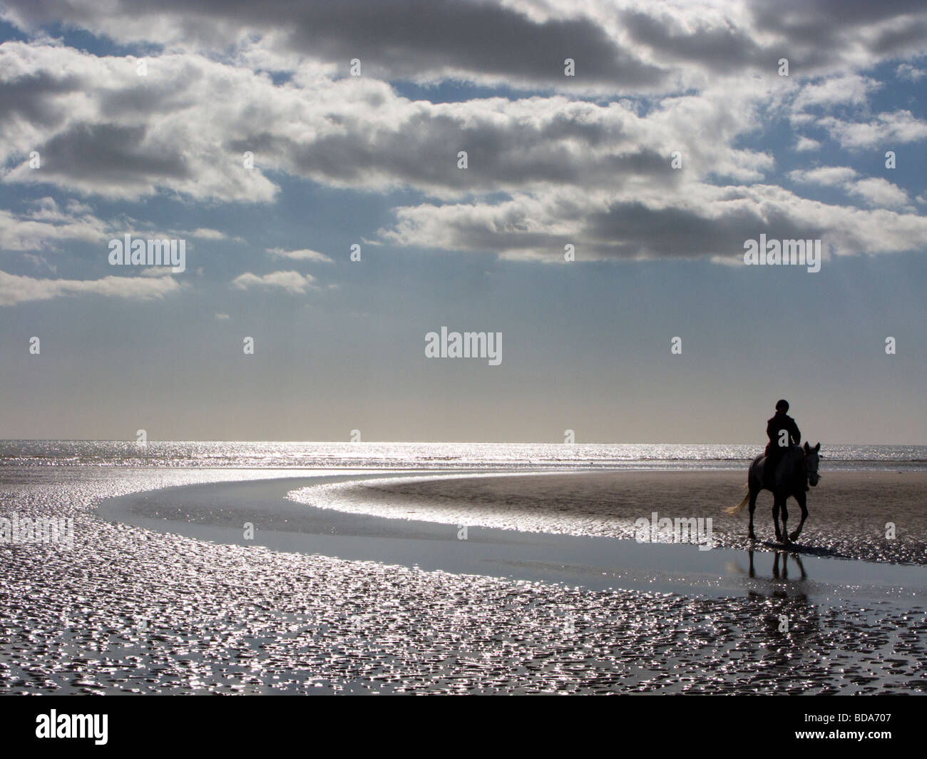 Silhouette of horseman, Camber Sands, East Sussex, UK Stock Photo