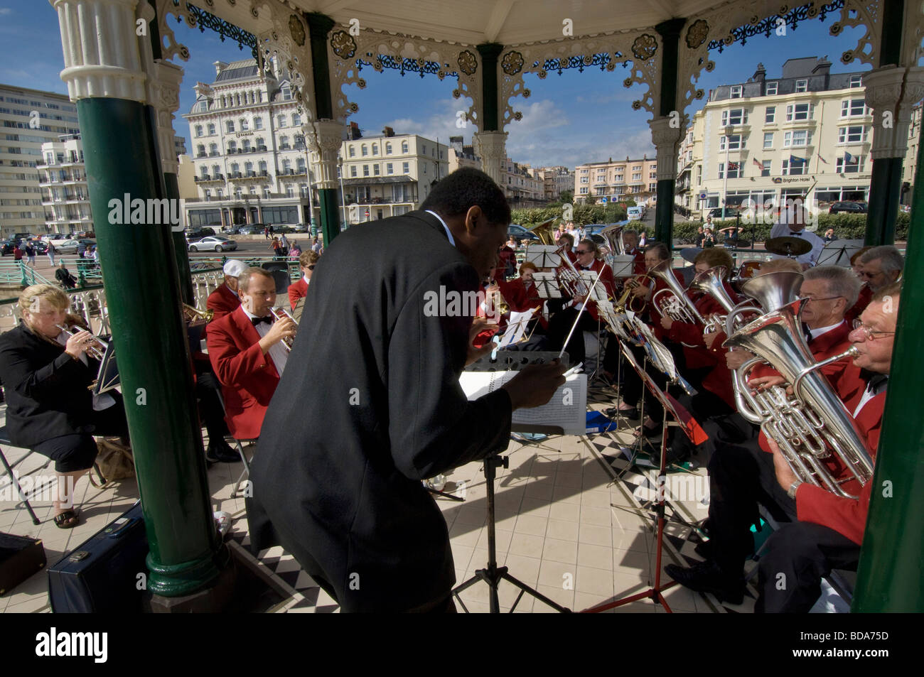 A  conductor leading the Patcham silver band in a concert on Brighton bandstand Stock Photo