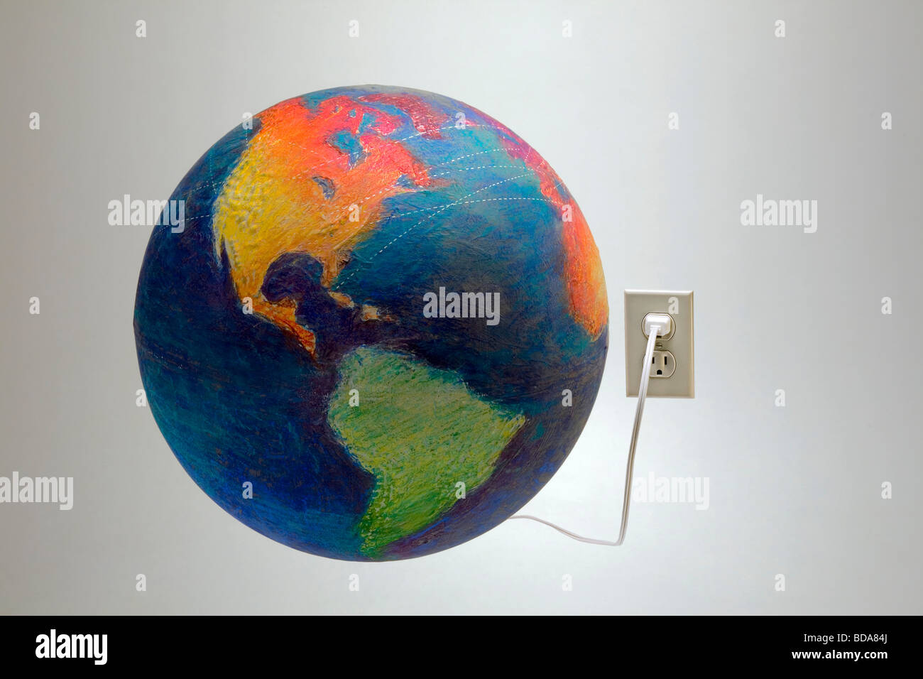 Still shot of a world globe plugged into a wall socket Stock Photo - Alamy