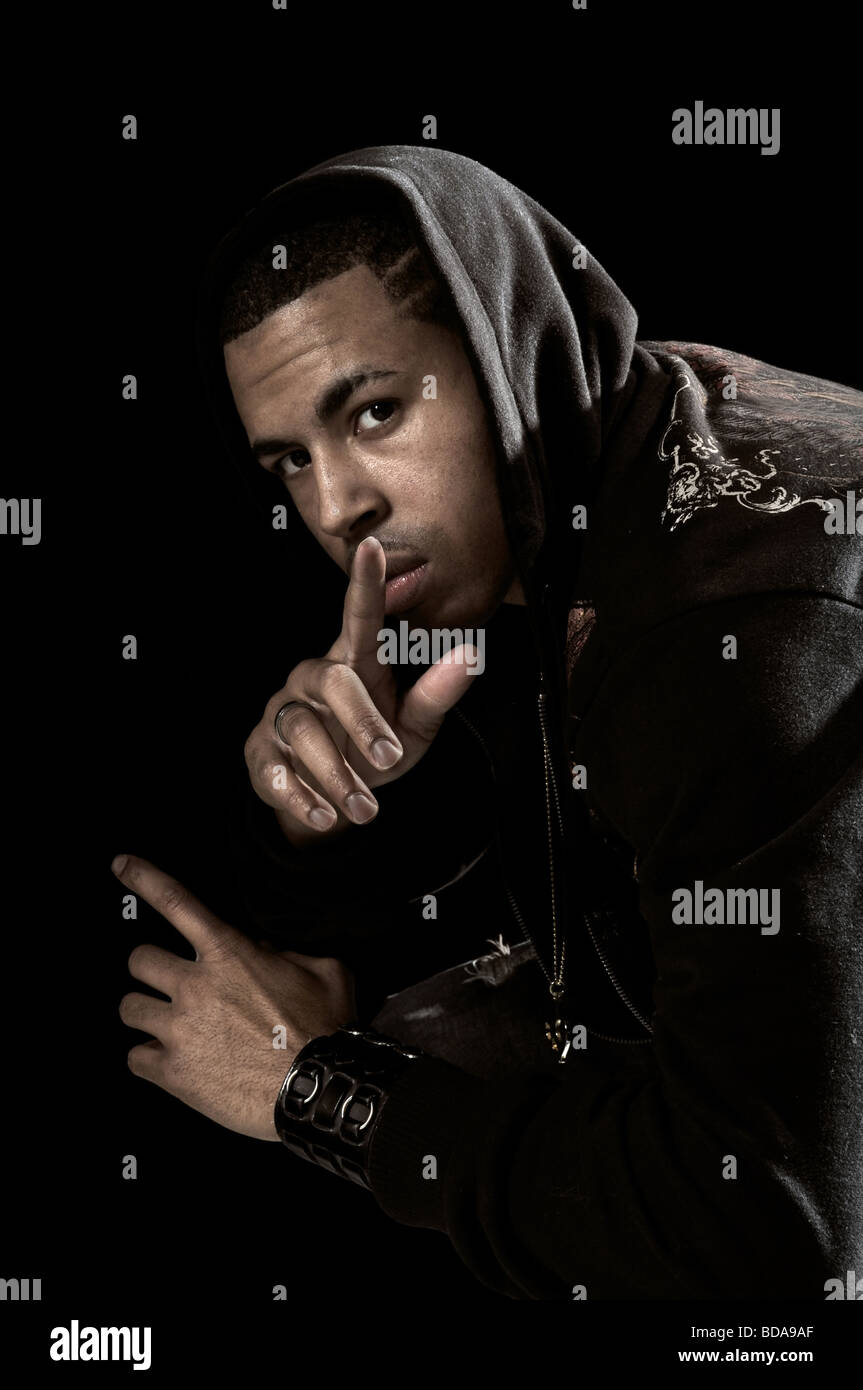 Portrait of African American man with hood over a black background ...